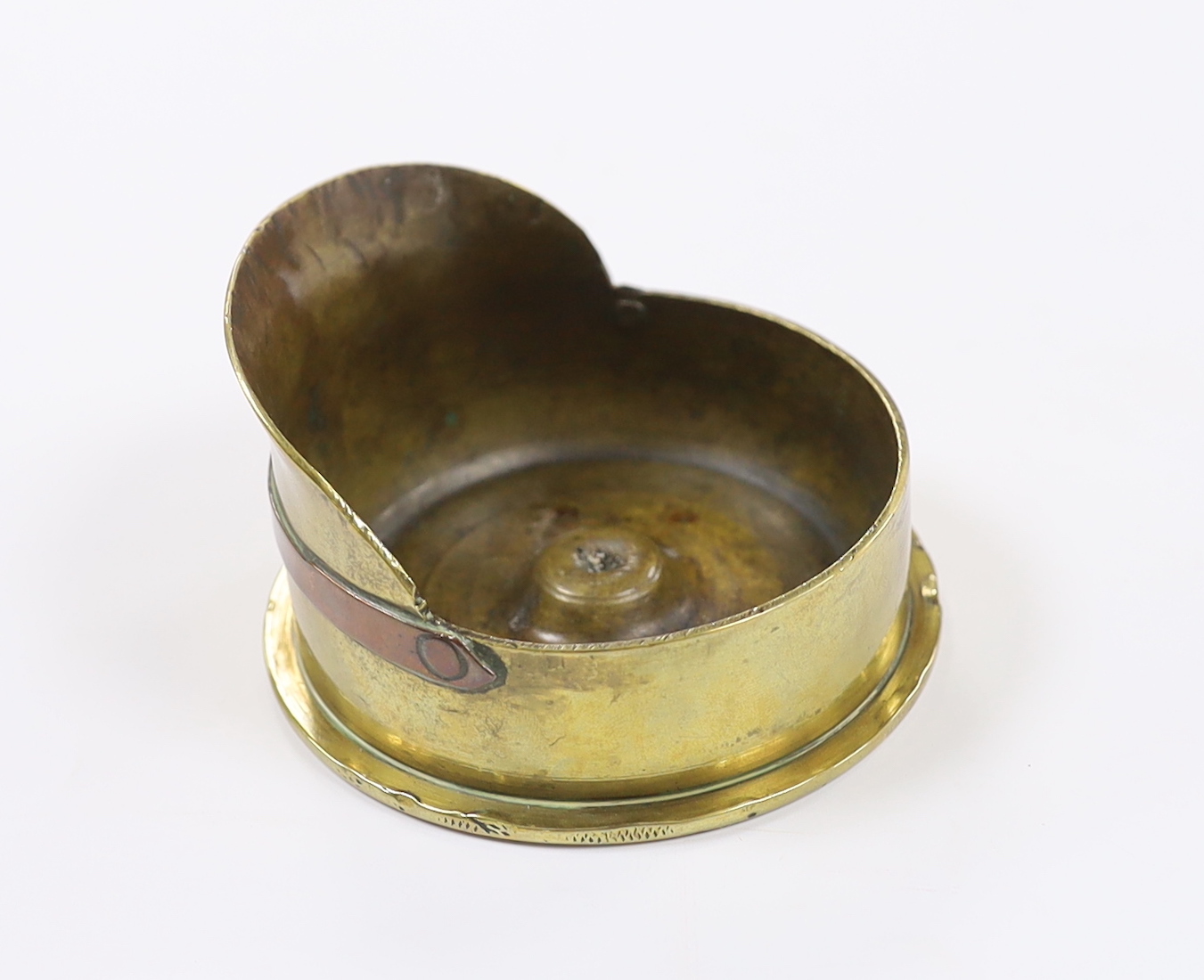 A First World War trench art worked brass cartridge case in the form of a peaked cap